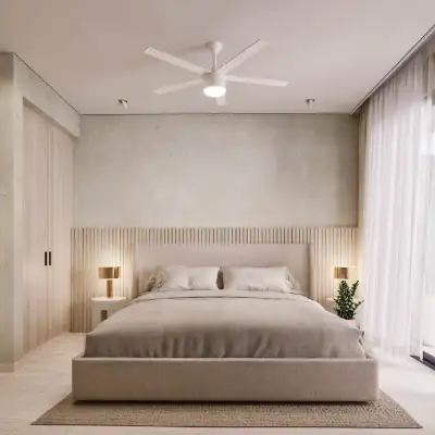 Neutral-toned bedroom with a white ceiling fan, soft bedding, and warm ambient lighting at Atzaro Residences, Playa del Carmen