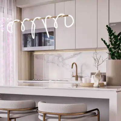 Bright modern kitchen featuring a white marble island with a brushed gold faucet and minimalist cabinetry at Atzaro Residences, Playa del Carmen