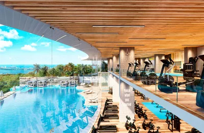 Pool and gym with wood ceiling at Aurora Towers, Cancun