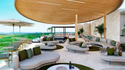 Rooftop lounge with canopy and ocean view at Aurora Towers, Cancun