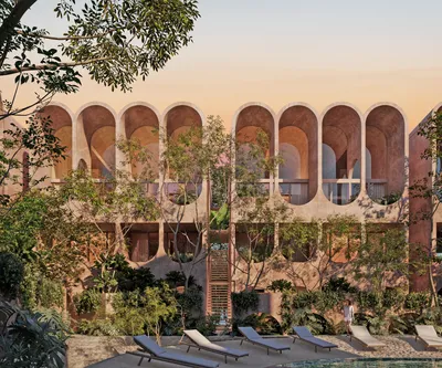Arched facade with pool and loungers at Babel Tulum