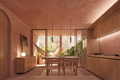 Dining area with hammock and pink walls at Babel Tulum