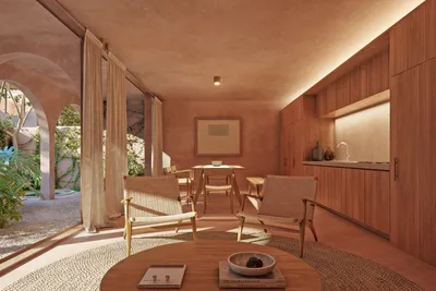 Living room with arched windows and garden at Babel Tulum