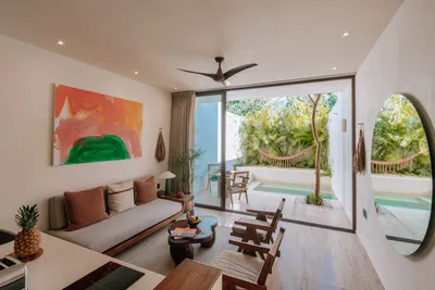 Living area with art and pool view at Bacab Tulum