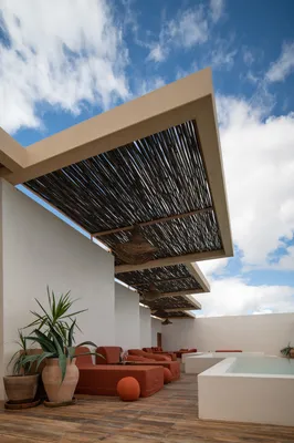 Rooftop terrace with thatch sofa at Bacab Tulum