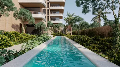 Garden pool with palm trees and tower at BAO Puerto Morelos