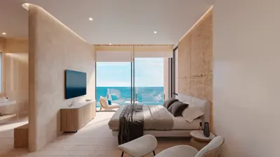 Living room with TV and sofa overlooking ocean at BAO Puerto Morelos