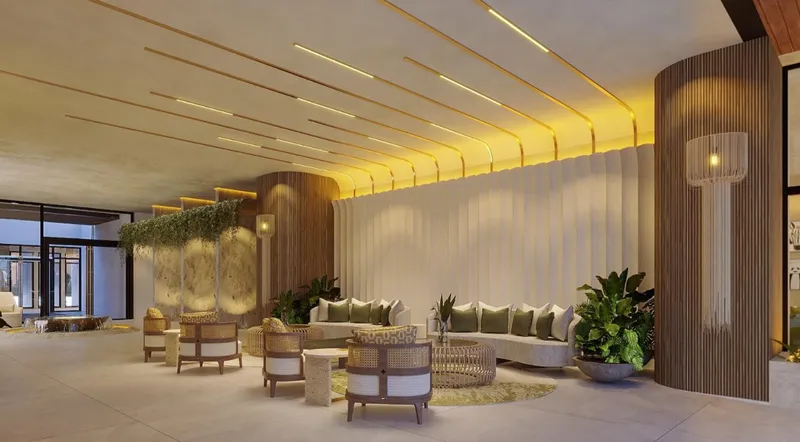 Lobby lounge con áreas de estar y diseño biofílico en torre BLAS en Puerto Cancún