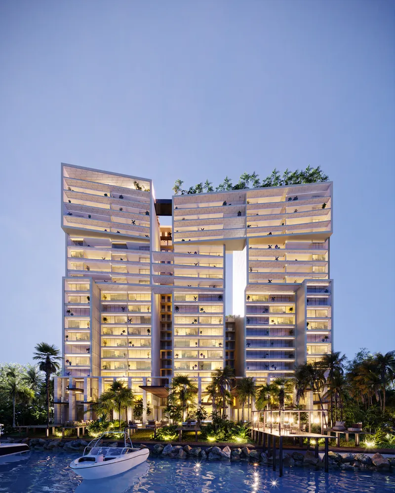 Torres gemelas al atardecer con alberca iluminada en residencia de lujo wellness BLAS en Puerto Cancún
