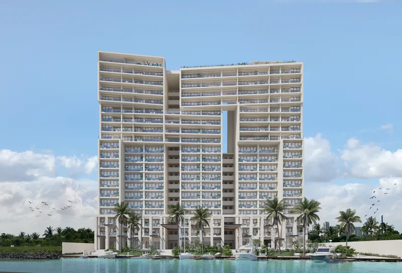 Vista diurna de torres gemelas con alberca estilo resort en residencia de lujo BLAS en Puerto Cancún