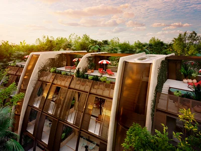 Curved Faena residences exterior with dramatic architecture integrated into the Tulum jungle landscape