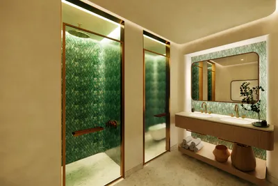 Double vanity bathroom with natural stone countertops and premium fixtures at Faena Tulum branded residence