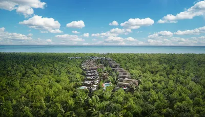Aerial masterplan view of Faena Tulum Résidences showing curved architecture nestled between jungle and Caribbean Sea