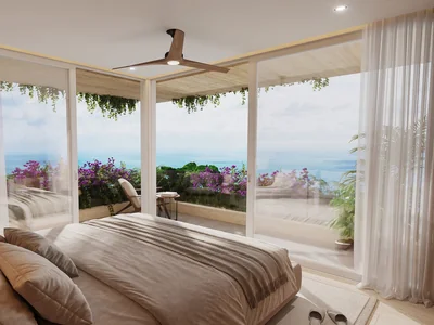 Recámara con balcón y vistas al océano en residencia inspirada en wellness Idilik en Playa del Carmen