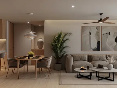 Sala abierta y cocina con acceso a balcón en condominio wellness Idilik en Playa del Carmen