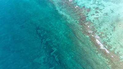 Aerial view of turquoise reef and deep blue ocean off the coast of Tulum, Quintana Roo