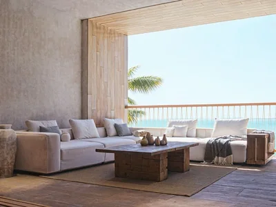Living room with sea view balcony and floor-to-ceiling glass at Maranta Tulum residence