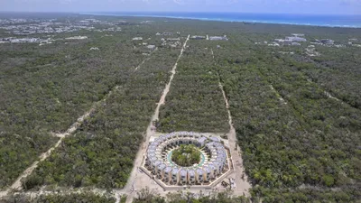 Aerial view of jungle with circular cenote at Mistiq Villas, Tulum