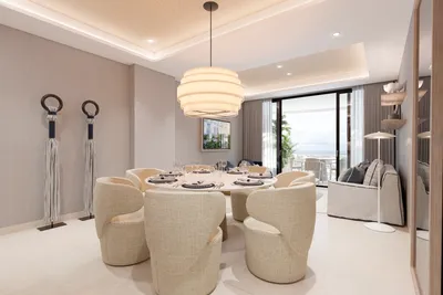 Dining room with pendant lights and ocean view at Nautica Residences, Cancun