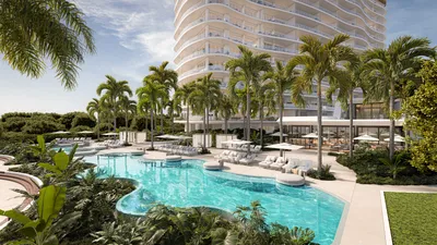 Pool deck with palm trees at One Laguna, Cancun