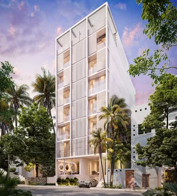 Fachada en calle con palmeras en Portha, Playa del Carmen