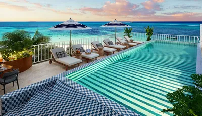 Alberca infinity con vista al atardecer sobre el océano en Saint Marine, Playa del Carmen