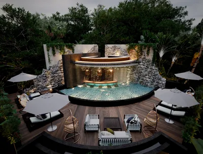 Circular pool with wooden sundeck surrounded by tropical jungle at Siwa Elevé wellness resort in Tulum