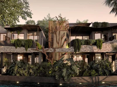 Siwa Elevé jungle residences at dusk with warm lighting and tropical vegetation in Tulum, Quintana Roo