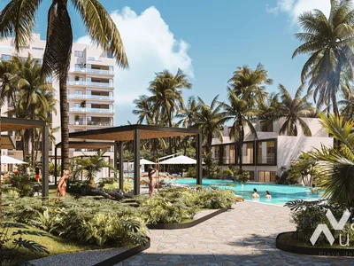 Resort-style pool with palm trees and amenities at Valle Aurora residential condominium in Playa del Carmen