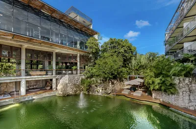 Cenote-style pool with fountain at Xalet Tulum