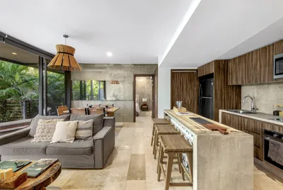 Living room with kitchen island at Xalet Tulum